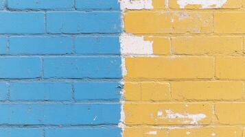 Two-tone brick wall divided into blue and yellow sections with peeling paint in urban setting photo
