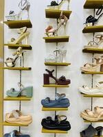 a display of shoes on shelves in a store in Lahore on July 28, 2024. photo
