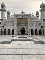 the interior of a white mosque with a fountain in Lahore on July 28, 2024. photo