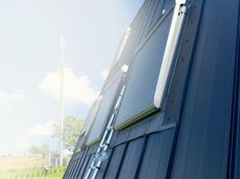 Installation of a solar-powered remote control electrical system on the skylight. photo
