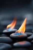 Flames rising from smooth stones on a dark surface in a tranquil setting photo