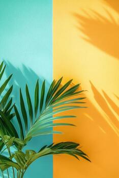 A vibrant green plant branch against a colorful blue and yellow background in a bright setting photo