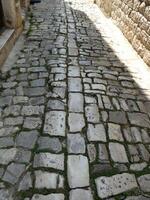 Ancient cobblestone pavement in Trogir, Croatia photo