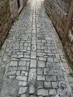 Ancient cobblestone pavement in Trogir, Croatia photo
