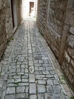Ancient cobblestone pavement in Trogir, Croatia photo