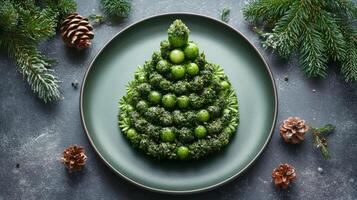Festive holiday decoration with a small tree, red ornaments, and green plate on a textured surface photo