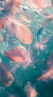 Delicate pink feathers gently float in a shimmering blue background with soft bubbles photo