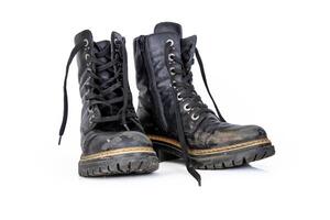 Pair of rugged worn black ankle leather combat boots with thick, sturdy soles and laces. Two vintage military style shoes. Studio light. Isolated on white background. Empty copy space. Clipping path photo