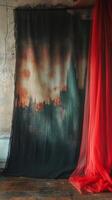 A mysterious backdrop with red curtains framing a foggy, urban landscape in dim lighting photo