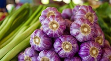 Freshly harvested purple garlic displayed at a vibrant farmer's market in autumn season photo