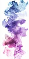 Swirling purple and pink smoke on a white background creates an ethereal and vibrant effect photo