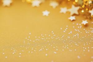 Gold and black stars scattered on a bright yellow background for festive celebrations photo