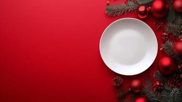 A festive empty plate surrounded by Christmas decorations on a vibrant red table photo