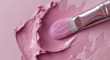 A close-up of a paintbrush applying lavender paint to a textured canvas surface in an art studio photo