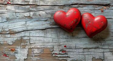 Three red decorative hearts resting on a rustic wooden table in soft natural light photo