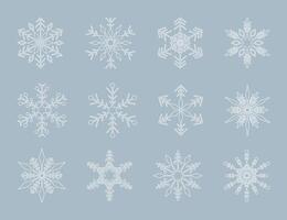 Set of white geometric shape snowflakes on blue background vector