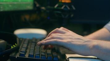Concentrated Caucasian crypto trader man male late night work touching keys keyboard computer freelancer boy worker looking monitor writing statistics at home stock analyzing results digital banking video