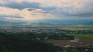 top view of rice fields with villages against background of mountains in Vietnam in Asia in the evening video
