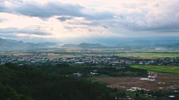 top view of rice fields with villages on background of mountains in Vietnam in Asia in evening video