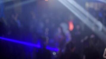 crowd of people dancing on the dance floor of a night club under the light of colored spotlights and lasers video