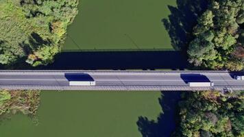 Traffic on the bridge that crosses the river video