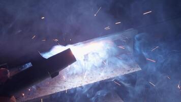 Welder uses torch to make sparks video