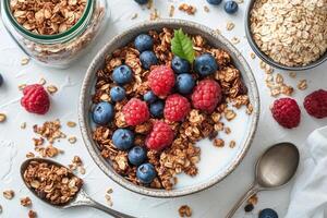 Healthy breakfast bowl with granola, fresh berries, and yogurt on a white background photo