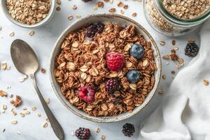 Healthy breakfast bowl with granola, fresh berries, and yogurt on a white background photo