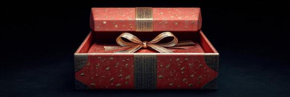 A beautifully wrapped red gift box with a golden bow glowing against a dark background photo