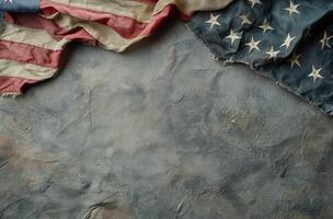 Tattered American flag displaying faded stars and worn fabric against a dark background photo
