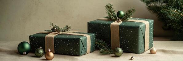 Festively wrapped green gifts with decorative accents and pine sprigs on a soft surface photo