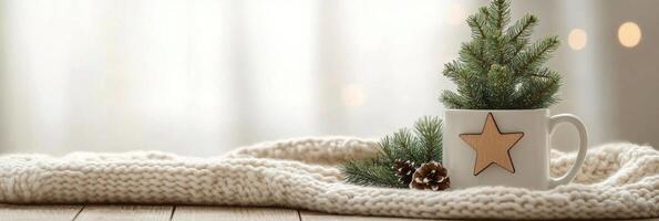 A cozy winter setting with a decorated mug and small evergreen plants on a soft blanket photo