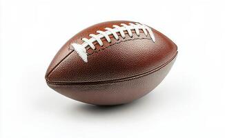 Brown leather football on a plain background, emphasizing its texture and stitching details photo
