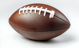 A close up view of a classic brown football displayed on a clean white background photo