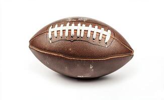 Brown leather football on a plain background, emphasizing its texture and stitching details photo