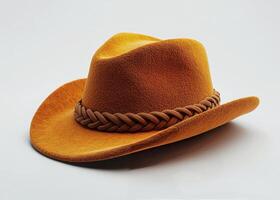 A stylish orange felt hat with braided leather band lying on a white background photo