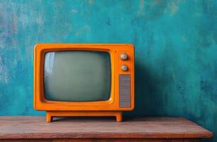 Retro yellow television set on a wooden table against a blue wall in a cozy indoor space photo