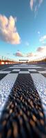 View of a racetracks checkered finish line under a bright blue sky during daytime photo