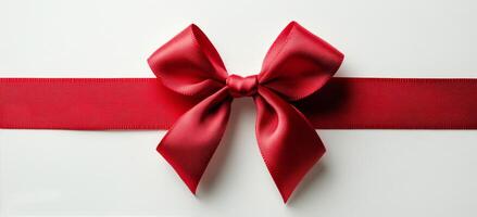 A beautifully crafted red ribbon and bow on a white background creating an elegant gift wrap photo