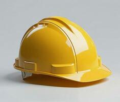 Worn yellow construction helmet placed on a clean surface highlighting its rugged features photo