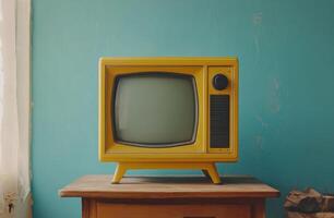 Retro yellow television set on a wooden table against a blue wall in a cozy indoor space photo