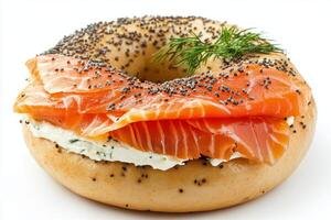 Delicious bagel with cream cheese, smoked salmon, and fresh dill arranged in a circular presentation photo