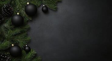 Festive black background with evergreen branches, pinecones, and black ornaments for holiday decor photo