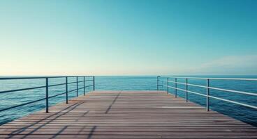 Wooden pier extending over calm blue waters on a clear sunny day photo