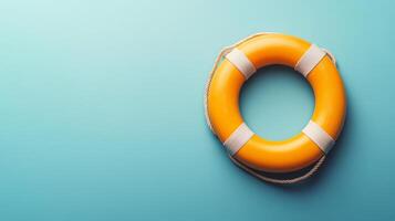 Bright yellow lifebuoy floating on a teal background, symbolizing safety and rescue at sea photo