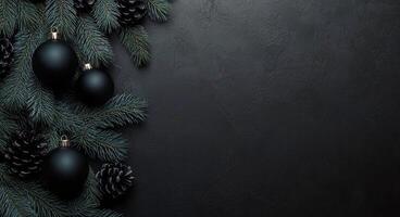 Festive black background with evergreen branches, pinecones, and black ornaments for holiday decor photo