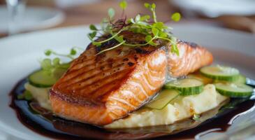 Freshly grilled salmon fillet served with creamy mashed potatoes and zucchini slices photo