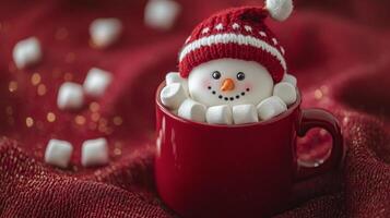 A cheerful snowman nestled in a red mug surrounded by marshmallows during winter festivities photo