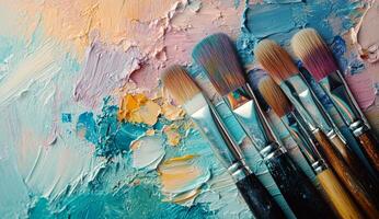 Colorful paint palette with brush strokes and paintbrushes resting on a vibrant surface photo