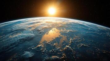 The sun rises majestically, casting golden hues over Earth's surface and cloud formations photo